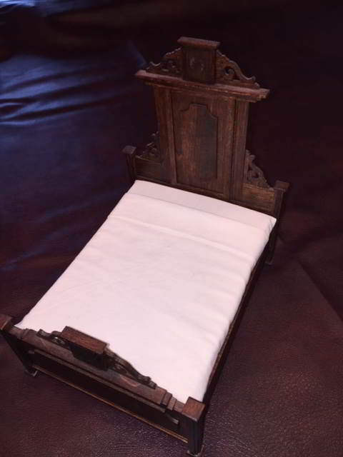 heirloom wooden bed without bedding