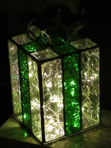 Barbara's first gift box in green 'ribbon' at night with internal lights on